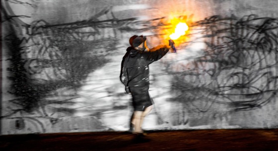 Artist sprays with fire on wall