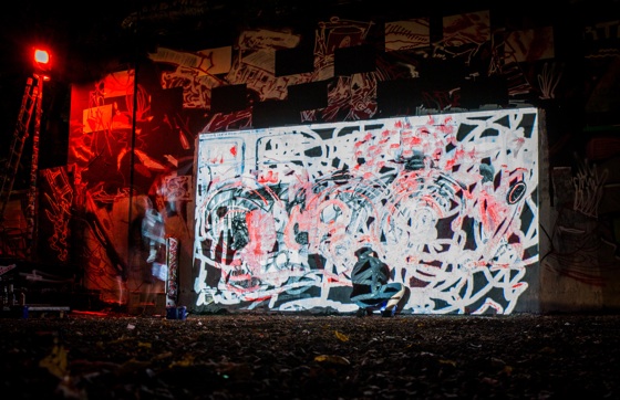 a large wall with projection and hidden artists