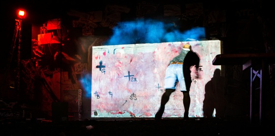 an artist throws a splashed can on the wall