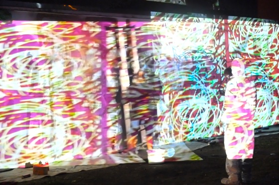 crazy iluminated wall with performance artist