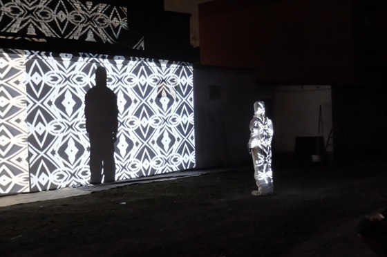 crazy iluminated wall with performance artist