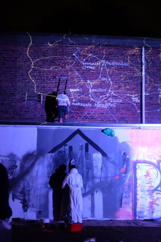 iluminated wall on two levels with Jens Besser painting on top