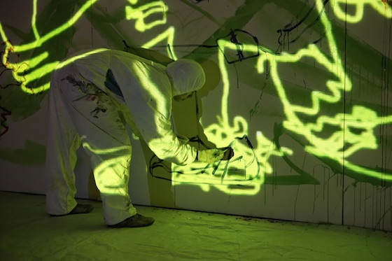 crazy iluminated wall with performance artist